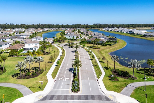 drone / aerial view with a residential view and a water view