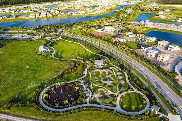 drone / aerial view with a residential view and a water view