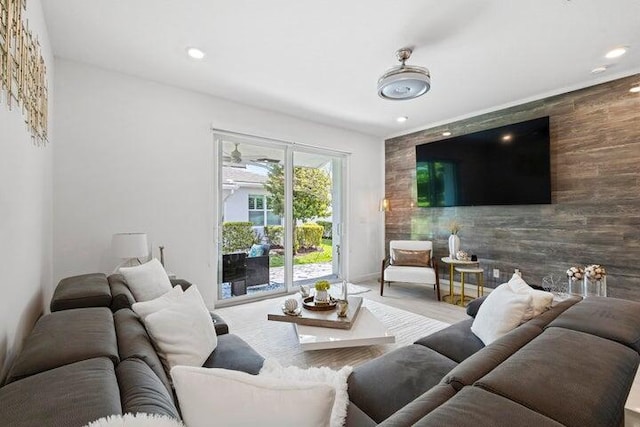 living area featuring recessed lighting, wood finished floors, and an accent wall