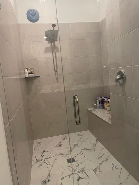 full bathroom featuring a shower stall