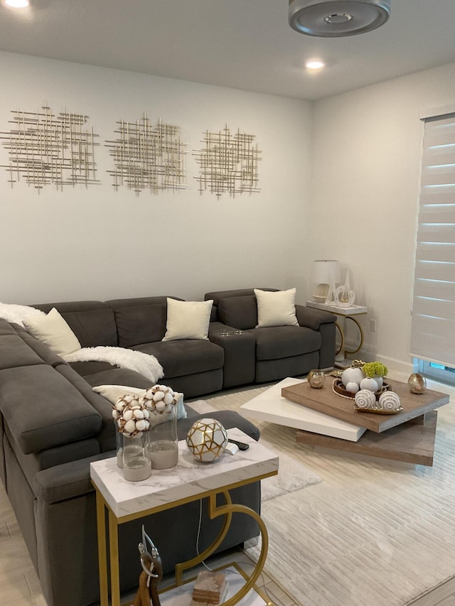 living room with recessed lighting, baseboards, and light wood-style flooring