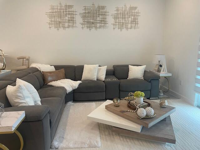 living room with light wood-style flooring and baseboards