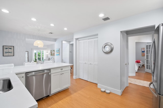 kitchen featuring visible vents, recessed lighting, stainless steel appliances, light wood-style floors, and white cabinetry