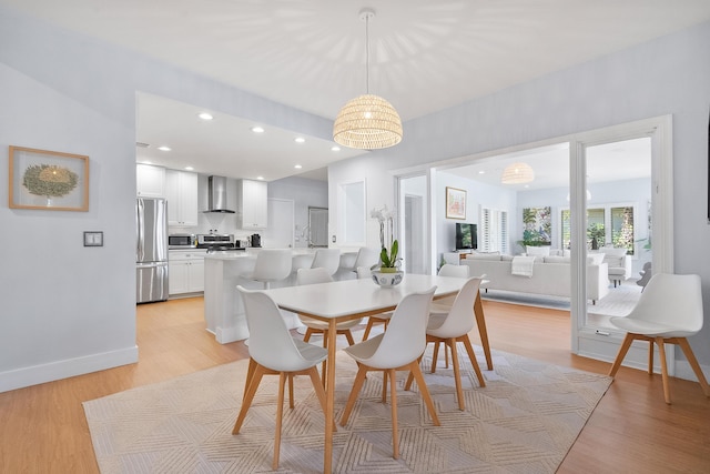 dining area featuring recessed lighting, light wood-type flooring, and baseboards