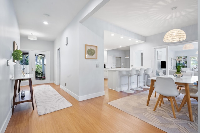 dining area with recessed lighting, baseboards, and light wood-style floors