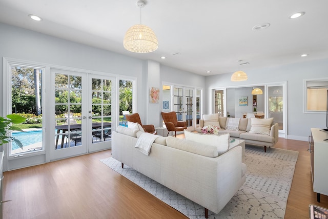 living area featuring recessed lighting, french doors, and wood finished floors