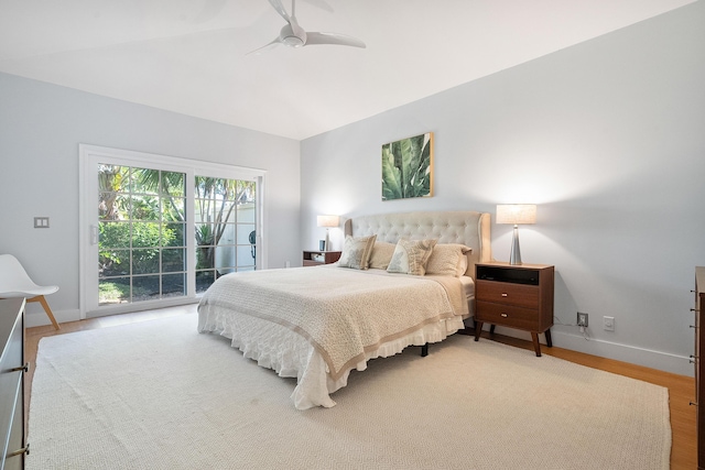 bedroom with a ceiling fan, access to exterior, wood finished floors, and baseboards