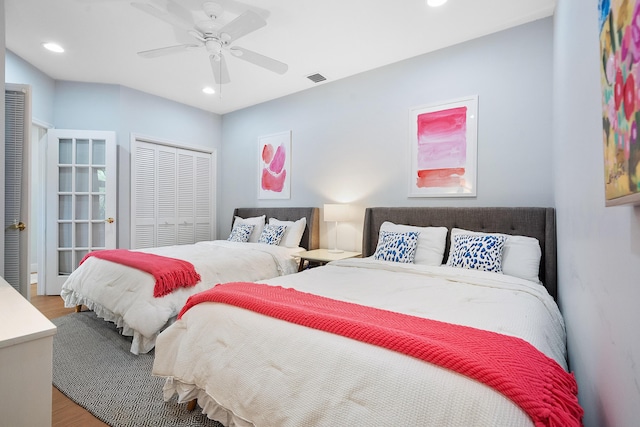 bedroom with recessed lighting, a closet, visible vents, and wood finished floors