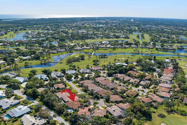 birds eye view of property with view of golf course, a water view, and a residential view