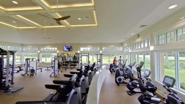 exercise room featuring visible vents, recessed lighting, coffered ceiling, and a high ceiling