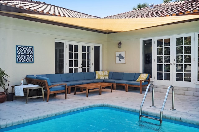 pool with a patio area, french doors, and an outdoor hangout area