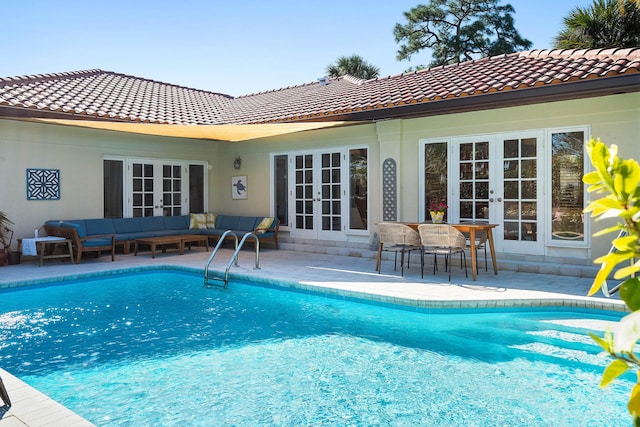 pool with french doors, a patio, and outdoor lounge area