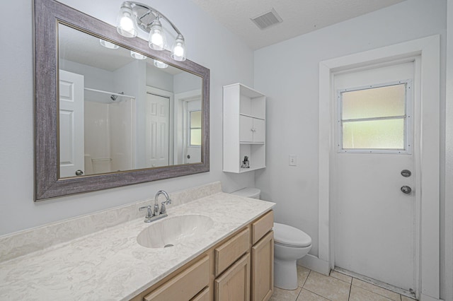 bathroom featuring vanity, visible vents, tile patterned flooring, a textured ceiling, and toilet