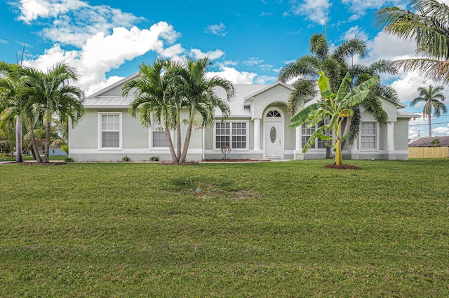 view of front of home with stucco siding and a front yard