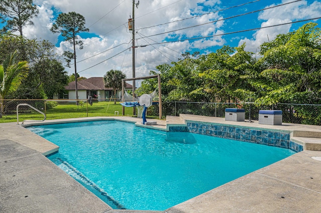 view of swimming pool with a yard, fence, and a fenced in pool