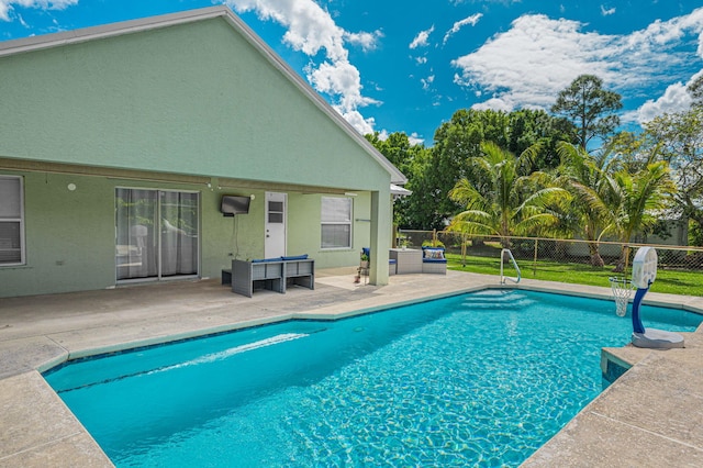 view of swimming pool with a patio, fence, and a fenced in pool