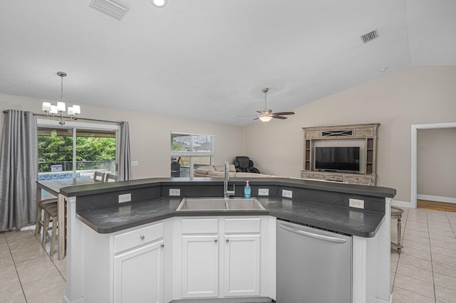 kitchen featuring visible vents, a sink, stainless steel dishwasher, dark countertops, and open floor plan