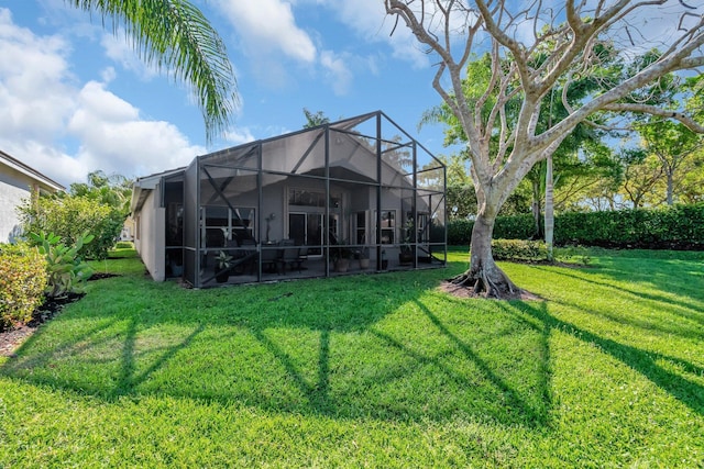 back of property with a lawn and glass enclosure