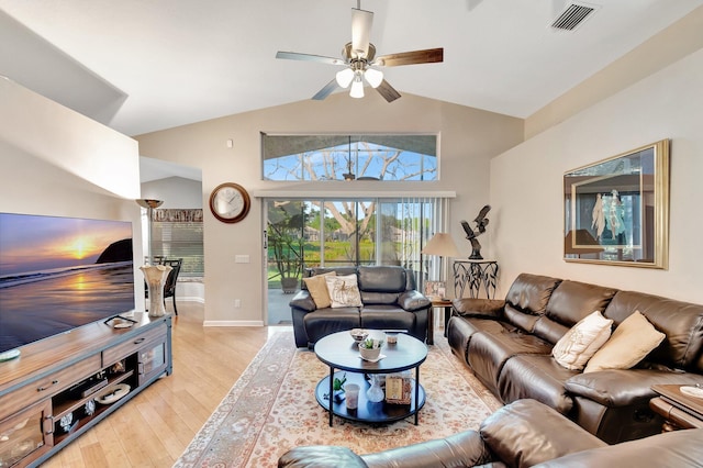 living room with a ceiling fan, visible vents, baseboards, lofted ceiling, and light wood-style floors