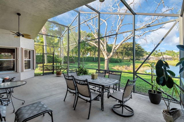 view of patio / terrace with a lanai, outdoor dining area, and ceiling fan