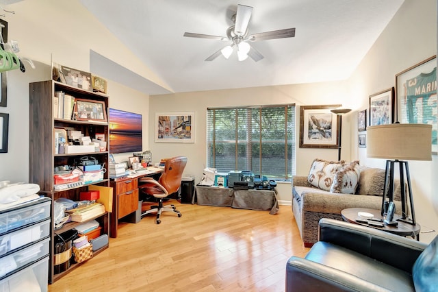 office featuring lofted ceiling, light wood-type flooring, and a ceiling fan