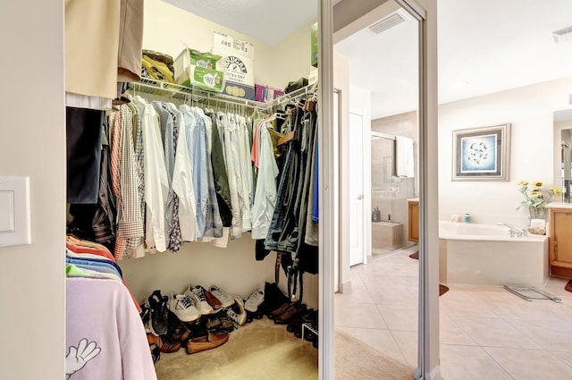 spacious closet with light tile patterned floors and visible vents