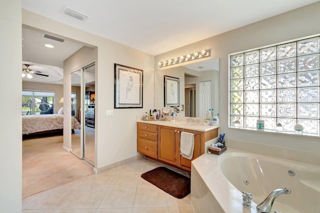 bathroom with visible vents, connected bathroom, vanity, tile patterned flooring, and a whirlpool tub