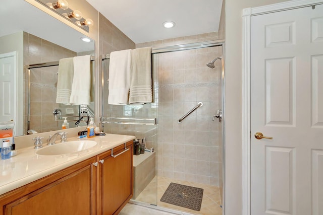 full bath featuring vanity and a shower stall