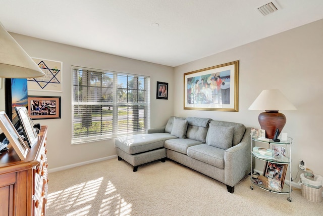 carpeted living area with visible vents and baseboards