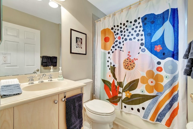 bathroom with shower / bath combination with curtain, toilet, and vanity