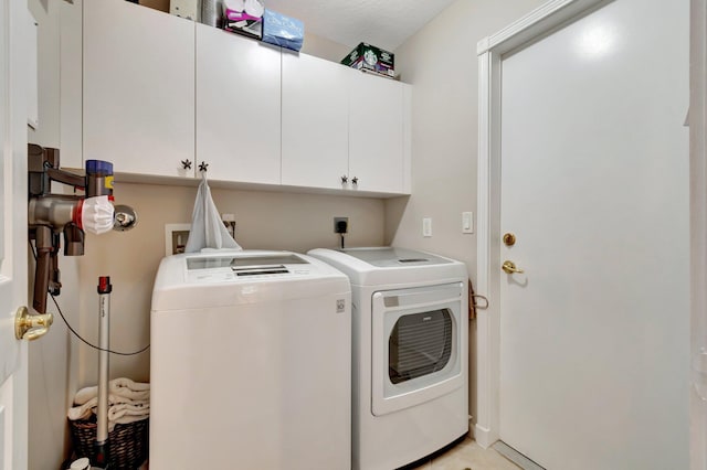 laundry room featuring cabinet space and independent washer and dryer