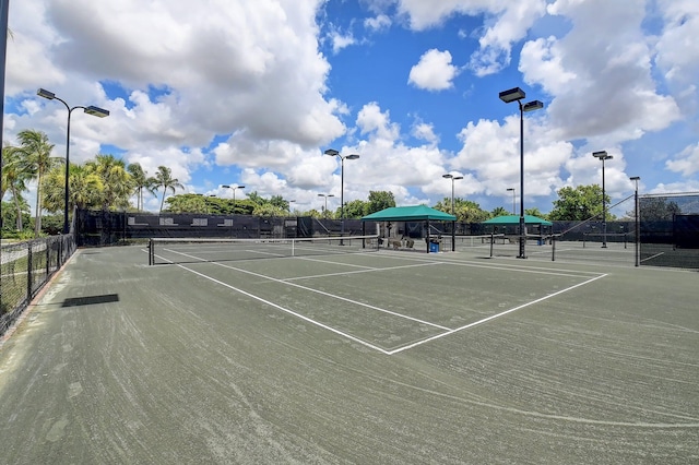 view of sport court featuring fence