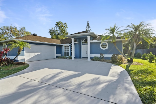 view of front of property featuring stucco siding, a garage, concrete driveway, and fence