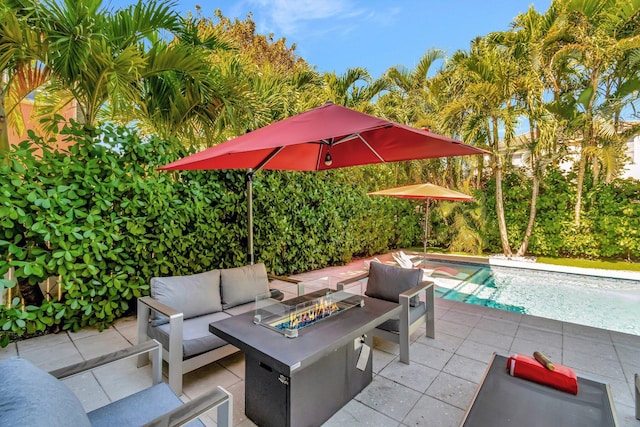 view of patio / terrace with an outdoor living space with a fire pit and an outdoor pool