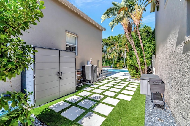 view of yard with a patio area and an outdoor pool