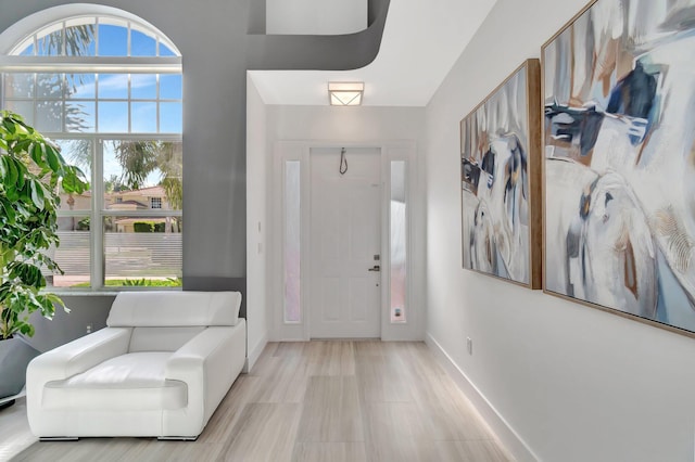 foyer entrance featuring baseboards