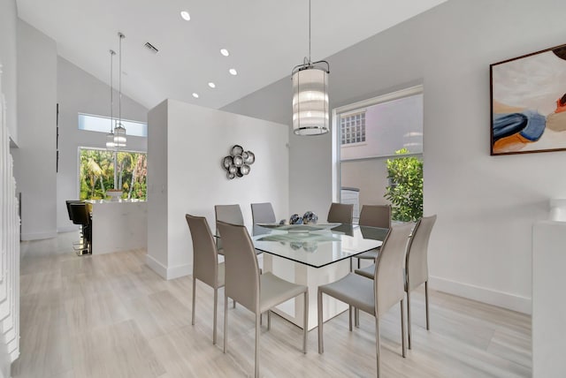 dining space featuring recessed lighting, visible vents, baseboards, and high vaulted ceiling