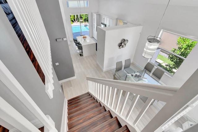 stairway featuring baseboards and wood finished floors