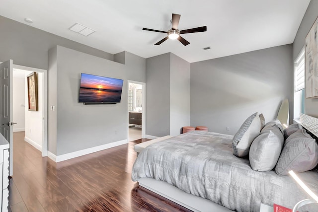 bedroom with visible vents, a ceiling fan, ensuite bath, wood finished floors, and baseboards