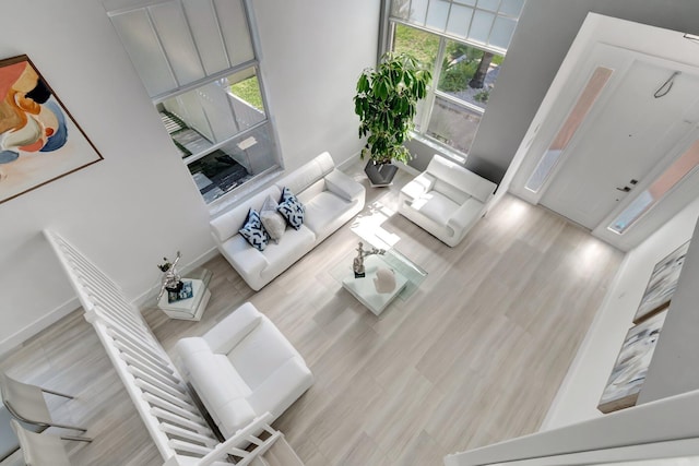 living area with baseboards and wood finished floors