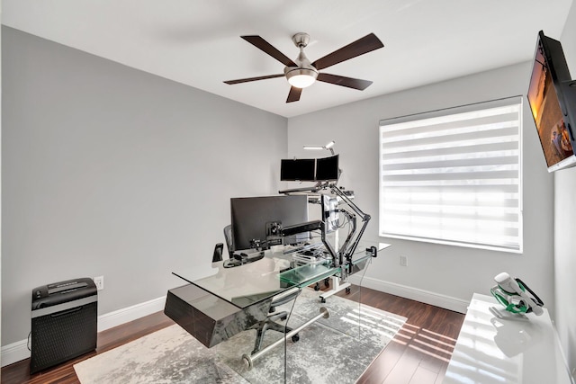 office space with a ceiling fan, wood finished floors, and baseboards