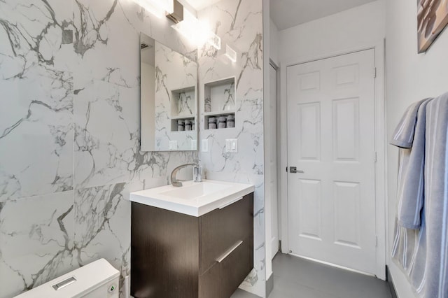 bathroom featuring toilet and vanity