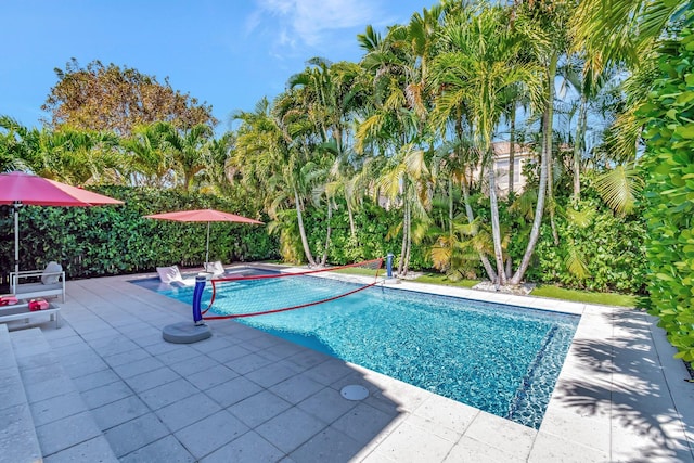 outdoor pool with a patio area