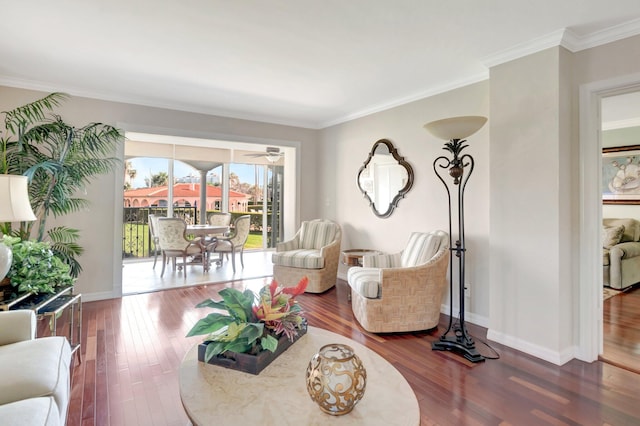 living room featuring wood finished floors, baseboards, and ornamental molding