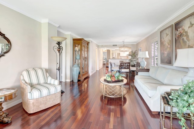 living area featuring baseboards, crown molding, an inviting chandelier, and wood finished floors