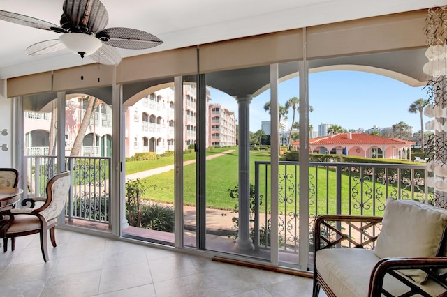 sunroom featuring a ceiling fan