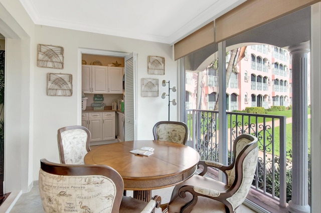 dining room featuring light tile patterned floors and crown molding