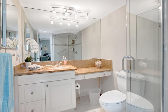 full bathroom featuring a shower stall, toilet, and vanity