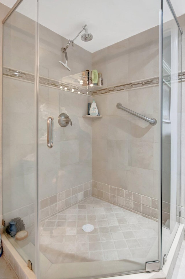 full bath with a shower stall