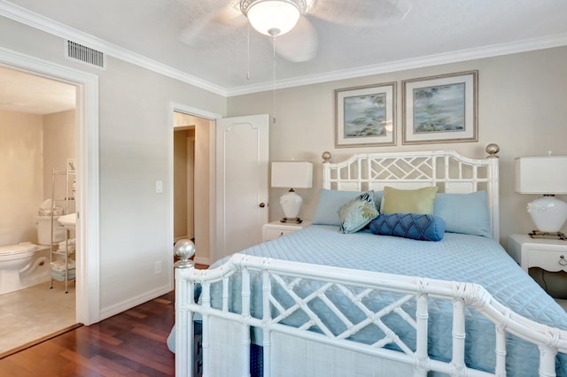 bedroom featuring dark wood-style floors, baseboards, visible vents, ornamental molding, and connected bathroom